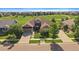 Aerial view of a single-Gathering home with beautiful landscaping and a well-manicured lawn near a golf course at 22023 E Heritage Pkwy, Aurora, CO 80016