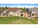 The backyard boasts a stone and siding exterior with a spacious yard, a balcony, and manicured landscaping at 22023 E Heritage Pkwy, Aurora, CO 80016