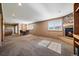 Open basement space with a fireplace, dining table, and access to a bar area at 22023 E Heritage Pkwy, Aurora, CO 80016
