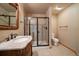Elegant bathroom with a granite vanity, framed mirror, and glass-enclosed shower stall at 22023 E Heritage Pkwy, Aurora, CO 80016