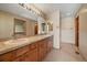 Bathroom featuring double sinks, light wood cabinets, and a walk-in shower at 22023 E Heritage Pkwy, Aurora, CO 80016