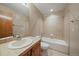 Bathroom with tile floors, wood cabinets, and a shower-tub combo at 22023 E Heritage Pkwy, Aurora, CO 80016