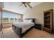Bedroom with high ceilings, carpeted floors, large windows with shutters and a queen sized bed at 22023 E Heritage Pkwy, Aurora, CO 80016