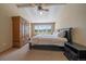 Bedroom with high ceilings, carpeted floors, and large windows with exterior views at 22023 E Heritage Pkwy, Aurora, CO 80016