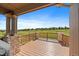 Inviting outdoor deck with wooden flooring, stone pillars, and views of the surrounding community at 22023 E Heritage Pkwy, Aurora, CO 80016