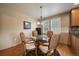 Dining nook featuring wood floors, three light chandelier, and natural light through shuttered windows at 22023 E Heritage Pkwy, Aurora, CO 80016
