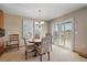 Bright dining area features a round table, chandelier lighting, and shuttered windows allowing natural light at 22023 E Heritage Pkwy, Aurora, CO 80016