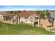 Beautiful multi-story home featuring stone accents, a well-maintained lawn, and a lush tree line at 22023 E Heritage Pkwy, Aurora, CO 80016