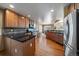 Bright kitchen featuring stainless steel appliances, wood floors, and dark countertops at 22023 E Heritage Pkwy, Aurora, CO 80016