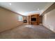 Cozy living room with a stone fireplace, carpet floors, and a built-in shelving unit at 22023 E Heritage Pkwy, Aurora, CO 80016