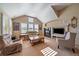 Inviting living room features vaulted ceilings, fireplace, large windows, and comfortable seating arrangements at 22023 E Heritage Pkwy, Aurora, CO 80016