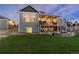 The exterior showcases a spacious backyard with a covered deck, lower patio, and a well-maintained lawn at 5181 Appleton Way, Castle Rock, CO 80104