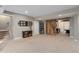 Large finished basement features a rustic sliding barn door, neutral decor, and ample space at 5181 Appleton Way, Castle Rock, CO 80104