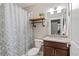 Bathroom featuring modern fixtures, granite counters, and a shower with a stylish curtain at 5181 Appleton Way, Castle Rock, CO 80104