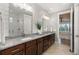 The bathroom features granite countertops, double sinks, wooden cabinets, shiplap accent wall and glass shower at 5181 Appleton Way, Castle Rock, CO 80104
