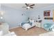 Cozy bedroom with a white bed, soft blue accents, ceiling fan, and natural light at 5181 Appleton Way, Castle Rock, CO 80104