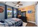Bedroom featuring wood accent wall, large windows, and blue accents at 5181 Appleton Way, Castle Rock, CO 80104