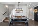 Inviting dining area with a modern chandelier, bench seating, and access to the staircase at 5181 Appleton Way, Castle Rock, CO 80104