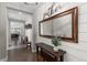 Stylish entryway with wood floors, shiplap wall, mirror and decorative accents at 5181 Appleton Way, Castle Rock, CO 80104