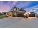 Beautiful two-story home with a three-car garage and a separate one-car garage and a large driveway at 5181 Appleton Way, Castle Rock, CO 80104