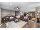 Open-concept living room boasts hardwood floors, neutral paint, and comfortable seating for entertaining at 5181 Appleton Way, Castle Rock, CO 80104
