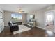 Bright living room with a large window, comfortable seating, ceiling fan and beautiful hardwood floors at 5181 Appleton Way, Castle Rock, CO 80104