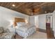 The main bedroom has a decorative wood ceiling, bright windows, and an upholstered accent chair at 5181 Appleton Way, Castle Rock, CO 80104