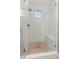 Modern shower with tile surround, mosaic tile floor, glass door and window at 5181 Appleton Way, Castle Rock, CO 80104