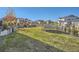 A large backyard features a trampoline and lush green grass surrounded by stone and decorative plants at 8137 Ralston Creek Ave, Littleton, CO 80125