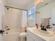 Bright bathroom featuring a shower-tub combo with white subway tile and a modern vanity at 8137 Ralston Creek Ave, Littleton, CO 80125