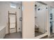 Bright bathroom with glass shower, marble tile, and a charming wooden ladder for towel storage at 8137 Ralston Creek Ave, Littleton, CO 80125