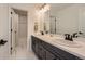 Bathroom showcasing double sinks, modern fixtures, and a separate bathtub with a shower at 8137 Ralston Creek Ave, Littleton, CO 80125