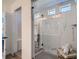 Modern bathroom featuring a glass-enclosed shower with marble tile and a stylish wooden towel ladder at 8137 Ralston Creek Ave, Littleton, CO 80125