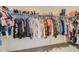 Organized walk-in closet with clothes hanging neatly on rods and shoes lined on shelves at 8137 Ralston Creek Ave, Littleton, CO 80125