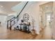 Welcoming foyer with hardwood floors, staircase, and decorative furnishings at 8137 Ralston Creek Ave, Littleton, CO 80125