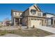 Beautiful two-story home featuring a stone facade, attached two-car garage, and well-manicured landscaping at 8137 Ralston Creek Ave, Littleton, CO 80125