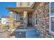 Inviting front porch showcasing stone pillars and a welcoming wreath on the front door at 8137 Ralston Creek Ave, Littleton, CO 80125