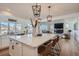 Open kitchen with a large island, pendant lights, and breakfast bar seating at 8137 Ralston Creek Ave, Littleton, CO 80125