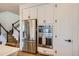 Bright kitchen features stainless steel appliances and staircase in background at 8137 Ralston Creek Ave, Littleton, CO 80125