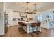 Spacious kitchen boasts a large island, white cabinetry, and modern pendant lighting at 8137 Ralston Creek Ave, Littleton, CO 80125