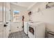 Efficient laundry room featuring modern appliances, patterned flooring, and ample storage at 8137 Ralston Creek Ave, Littleton, CO 80125