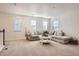 Bright living room featuring a comfortable sectional sofa, perfect for relaxing and entertaining guests at 8137 Ralston Creek Ave, Littleton, CO 80125