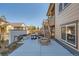 A patio features a built in firepit, patio seating, and an outdoor staircase to the upper level deck at 8137 Ralston Creek Ave, Littleton, CO 80125