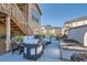 A patio features an outdoor seating set, planters with decorative flowers, and a built-in gas firepit at 8137 Ralston Creek Ave, Littleton, CO 80125