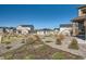 A street view features the gravel landscaping, wooden fencing, and the neighborhood homes in the background at 8137 Ralston Creek Ave, Littleton, CO 80125