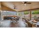 Outdoor dining on a covered back porch overlooking a well maintained yard, hot tub and outdoor fireplace at 1479 Short Grass Ct, Castle Rock, CO 80109