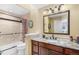Tiled bathroom with granite countertop vanity, shower and tub with glass door at 1479 Short Grass Ct, Castle Rock, CO 80109