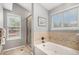 Bathroom with a soaking tub and shower, offering plenty of natural light at 1479 Short Grass Ct, Castle Rock, CO 80109