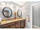 Bathroom features a double vanity, updated lighting, and neutral paint colors, creating a relaxing space at 1479 Short Grass Ct, Castle Rock, CO 80109
