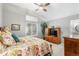 Comfortable bedroom offers a ceiling fan, natural light, and a view into the ensuite bathroom at 1479 Short Grass Ct, Castle Rock, CO 80109